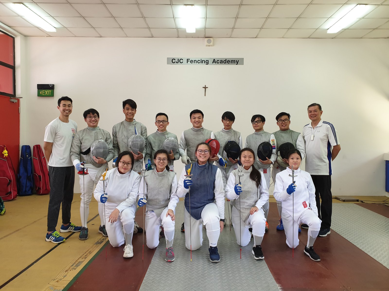 Coach Jeffrey Lopez and Coach Shaun-Paul Lopez with the Catholic Junior College fencing squad