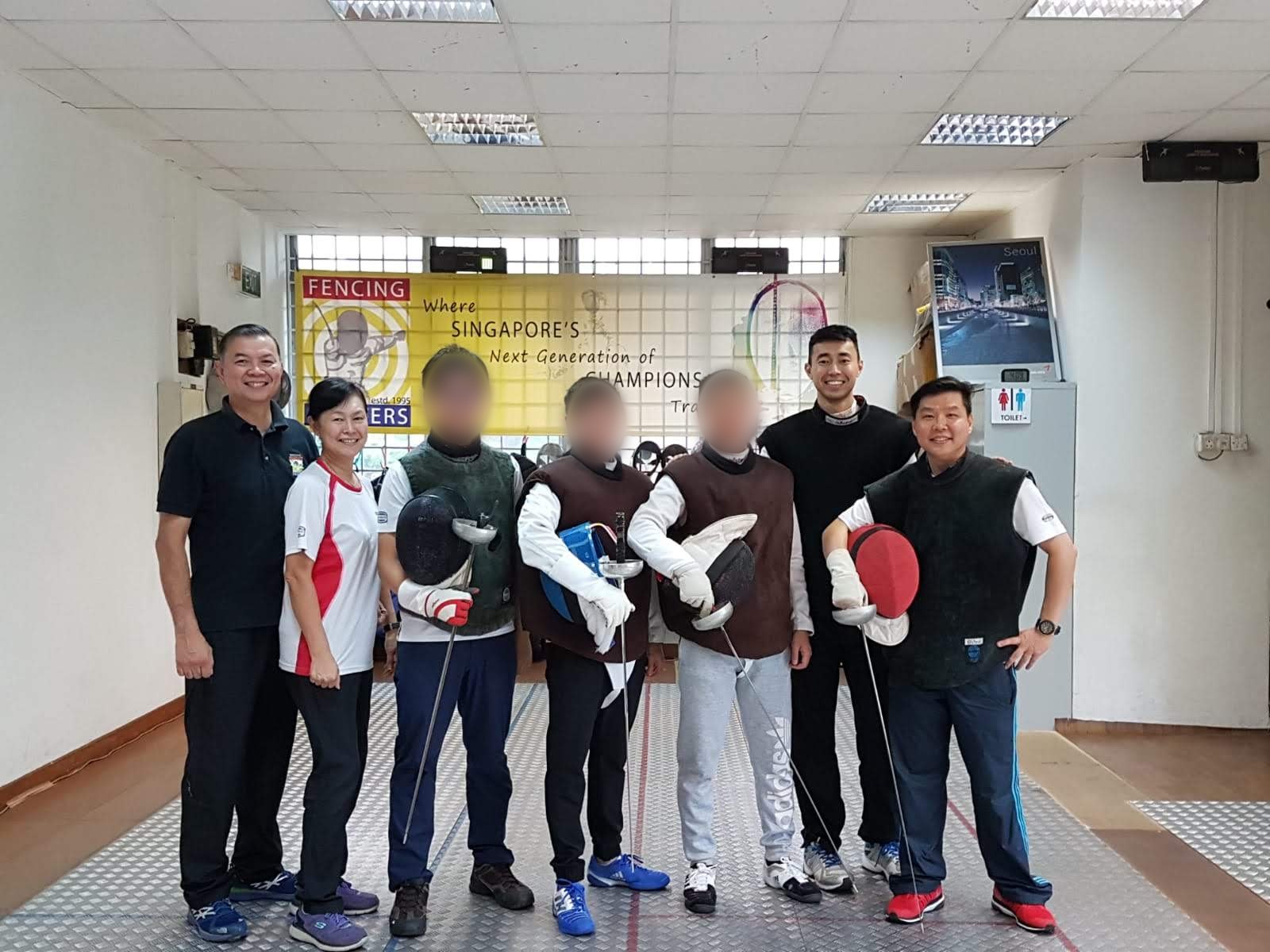 Coach Jeffrey, Coach Lois, Coach Shaun-Paul and Coach Kelvin with fencers in the Fencing Masters salle
